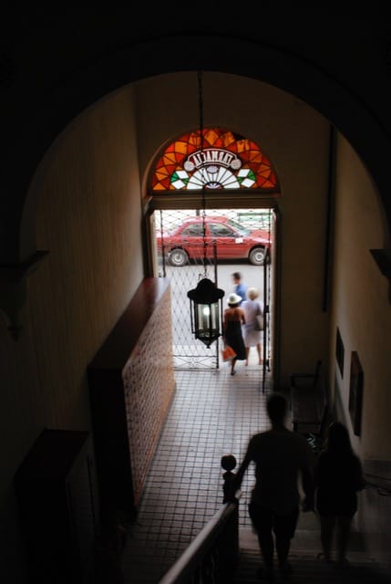 People walk down stairs leading out to the street.