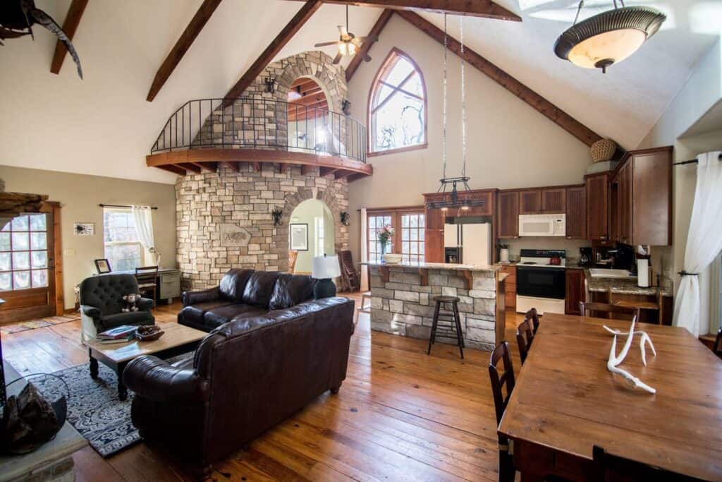 Interior of a home. A kitchen is in the back, with a living room in the forefront.