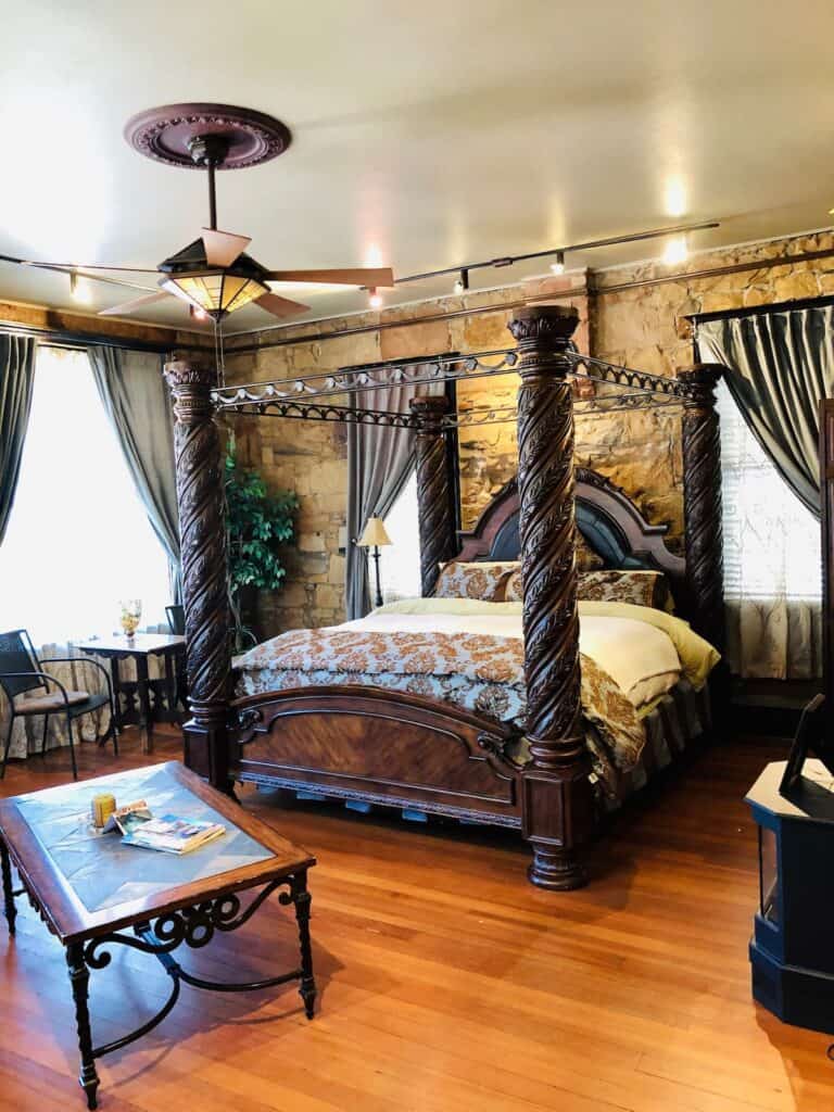 A bedroom features a tall king-style bed.