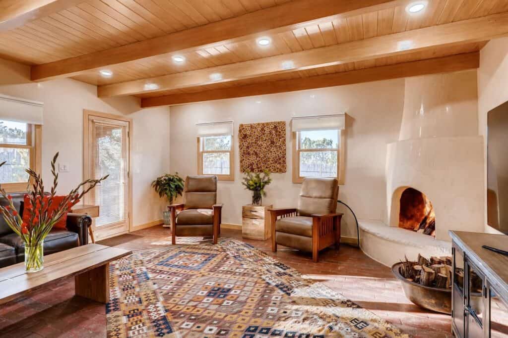 A living room has boho vibes with a fireplace.