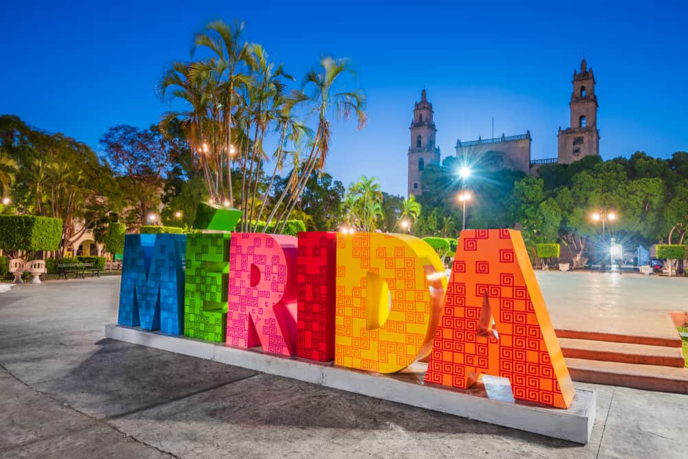 Colorful sign in a plaza says \"Merida.\"