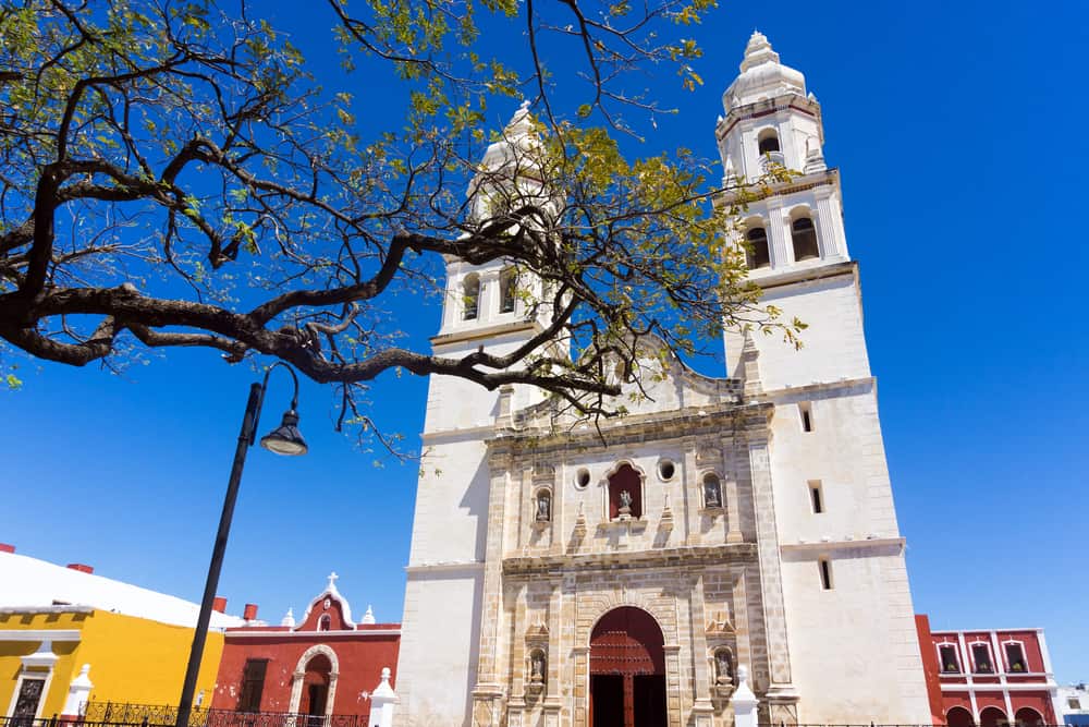 A tall white church under a blue sky.