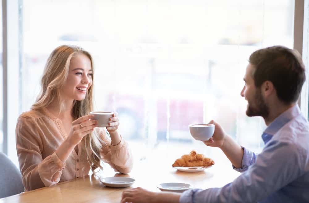 Man and woman talking at cafe flirty questions to ask a girl