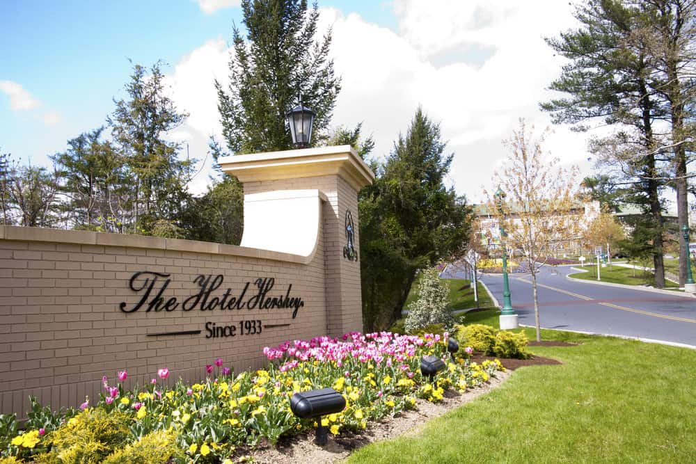 The entrance to the iconic Hotel Hershey with flowers on a sunny day